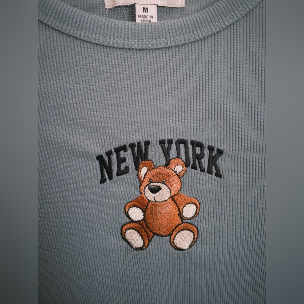 Selling a teal short sleeve top "New York", with a teddy bear on it!